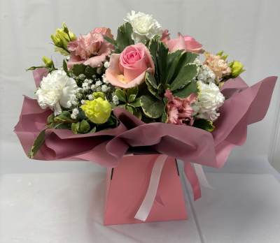 Rosie - A flower arrangement bursting with beautiful blooms in pale pinks, lilacs and whites.