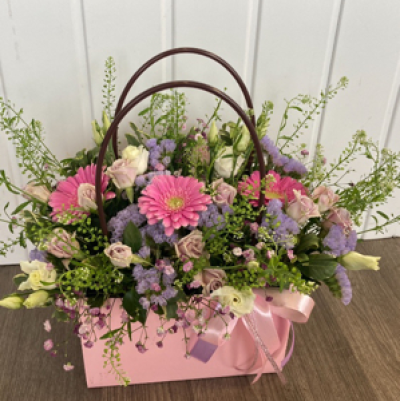 Perfect - Beautiful flowers arranged in oasis in a watertight handbag container
