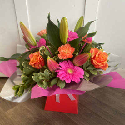 Gia - Gorgeous vibrant cerise pinks and oranges . Includes lillies and roses