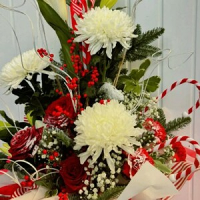 Cute Candy Cane - This flower box arrangement is part of our Luxury Christmas range. Bursting with candy cane decorations, blooms, lillies, roses, carnations, hypericum & foliage.