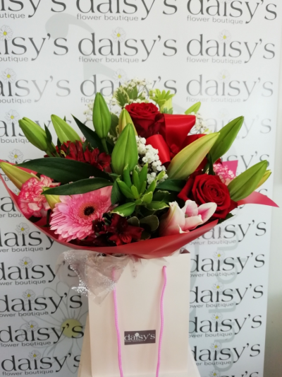 Ruby - A gorgeous handtied arrangement in red, pink & white. Seasonal flowers & foliages chosen which is presented in a gift bag