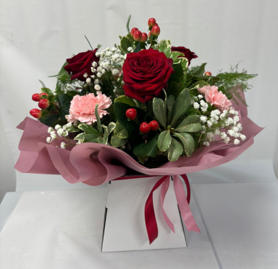 Ruby - A gorgeous handtied arrangement in red, pink & white. Seasonal flowers & foliages chosen which is presented in a gift bag
