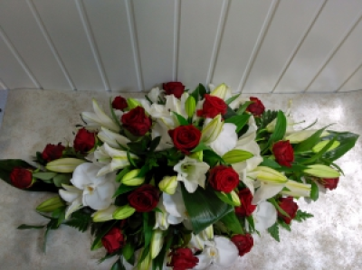 Double Ended Casket Spray - Double ended casket spray in a oasis water container. Contents - White lillies, red roses &  various foliages