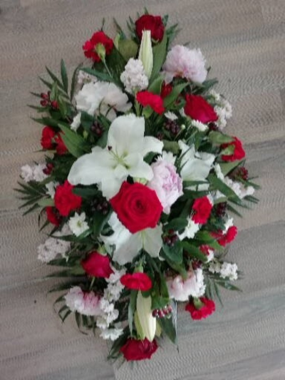 Casket Spray - Red, Pinks & Whites - A casket spray; filled with glorious red roses, white lillies & a mixture of red, white and pink flowers.

A stunning tribute for a lady or gentleman