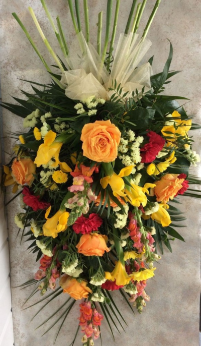 Single Ended Spray - Orange, Yellow & Red - Single Ended Spray suitable as a funeral tribute. Nice mix of fresh seasonal flowers in yellow, orange and red.