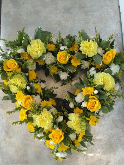 Loose Open Heart - Yellow & White - Beautiful loose open heart in yellow,lemon and whites. Contents include yellow roses, lemon carnations, white spray carnations, solidaster and a beautiful mix of foliages.