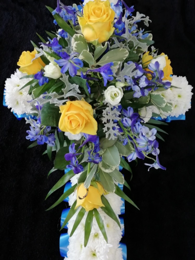Casket Cross - A stunning cross to be placed on top of the casket. The cross is based in white chrysanthemums & the cluster will contain seasonal flowers & foliages.

When placing your order please confirm your chosen colour choice of the flowers & ribbon edge