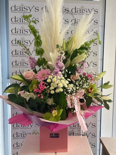 Our Wonderful Mum - A Luxury handtied arrangement presented in a gift box. This arrangement is bursting with luxury flowers & foliages perfect for Mother's Day and finished off with satin ribbons & pa