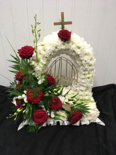 Gates Of Heaven - Red & White - Gates of Heaven funeral tribute massed in white chrysanthemums with a red and white cluster to include Red Roses. Finished of with a white ribbon edge.