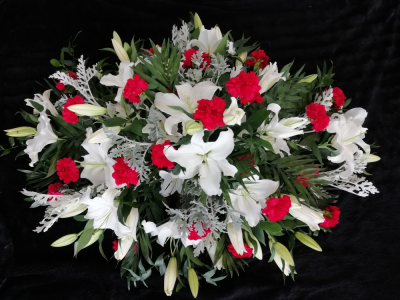 Casket Spray - Lillies & Carnations - A beautiful casket spray in reds & whites. Full of white lillies & red carnations with seasonal foliages.