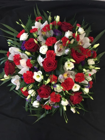 Posy Pad - Red, Purple & White - A Posy pad with a mixture of flowers in Red, Purple & White. This tribute will contain roses and a mixture of other flowers and foliages.

A beautiful tribute for a lady or gentlemen.