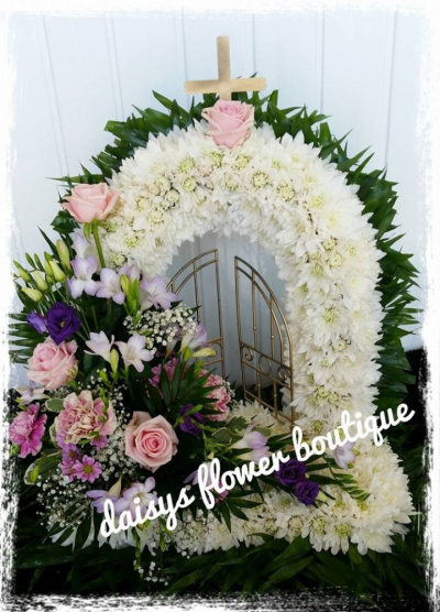 Gates Of Heaven - Pink & Purple - Gates of heaven tributed massed in white double chrsyanthemums with a pink & purple cluster. Finished off with a foliage edge