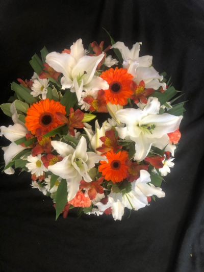 Wreath - Orange & White - A round traditional wreath in Orange & white; filled with seasonal flowers & foliages.