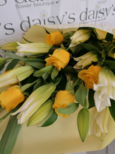 Dallas - A Bouquet filled with White oriental lillies & yellow Roses and beautifully presented wrapped in celophane with a bow