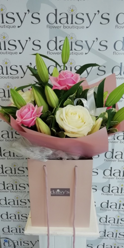Lily & Rose - A gorgeous handtied arrangement in pale pinks & whites; soley with Roses, Lillies & Greenery. This arrangement is presented in a gift bag with a satin bow