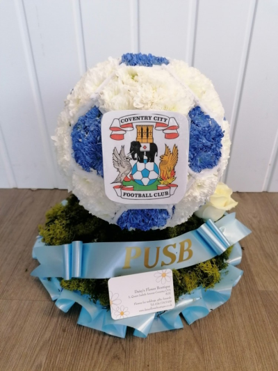 Coventry City Football - Football based in white crysanthenums with club badge & placed onto colour co-ordinating ribbon edged foliage with a rose cluster - £155

If you want the PUSB sash included please select the option at £160