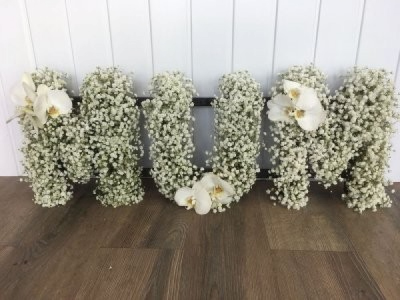 MUM - White Gypsophila & Orchids - A MUM tribute in letters massed in white gypsophila & clusters of white phalaenopsis orchid.
