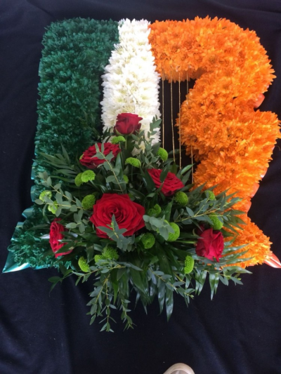 Irish Harp - An Irish Harp Funeral Tribute. Edged with ribbon, based in chrysanthemums & finished with a Red Roses, Kermit chryanthemum & foliage cluster.