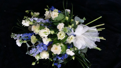 Single Ended Spray - Blue & White - A Single Ended Spray funeral tribute. A lovely selection of fresh seasonal flowers in white and Blue to include Roses and delphinium. Finished off with a beauitful white organze bow.