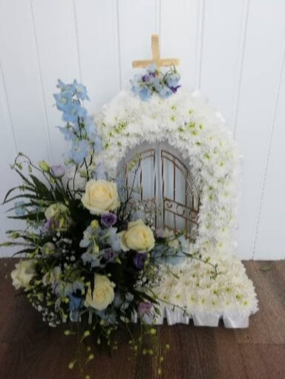 Gates Of Heaven - Sky Blue, Purple & White - Gates of heaven tributed massed in white double chrsyanthemums with a sky blue, white & purple cluster. Finished off with a white ribbon edge