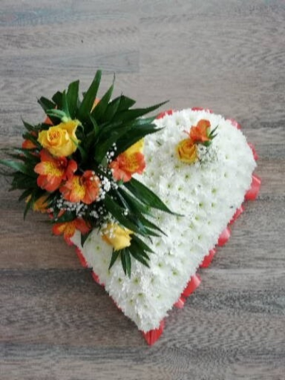 Based Heart - Yellow & Orange - A beautiful heart tribute. Edged with orange ribbon, massed in White Chrysanthemum and a cluster of Yellow Roses & a mixure of flowers & foliages