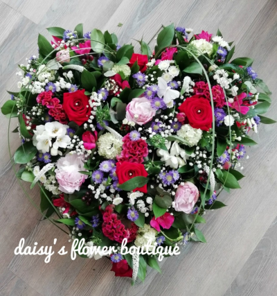 Heart - Red, Pinks, Purple & Whites - A beautiful loose full heart in Red, pink, white & purple. Contents include Red Roses and a mixture of flowers & foliages