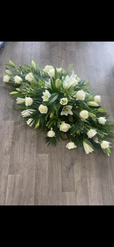 Casket spray - Subtle and classic selection of white roses and white lillies