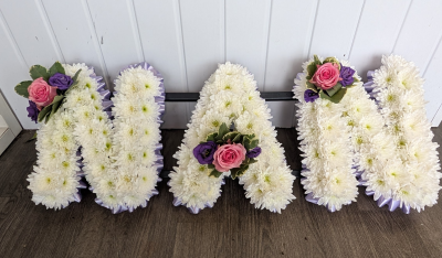 NAN - Pink & Purple - A beautiful Nan tribute with a lilac ribbon edge, white based chrysanthemums and a pink & purple cluster.