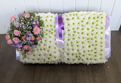 Open Book Tribute - An open book tribute with a ribbon edge, white based chrysanthemums & a pink and lilac cluster