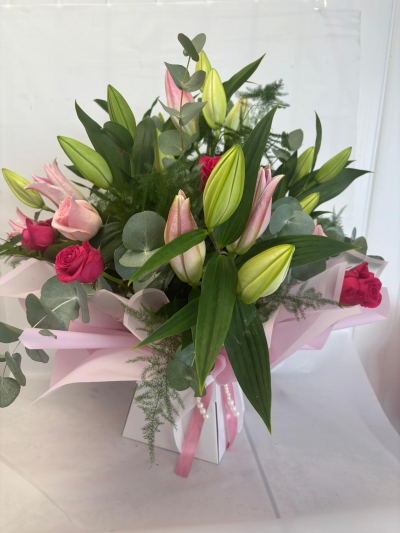 Charlotte - One of our Luxury designs filled with a mix of foliages and bursting with lillies & roses