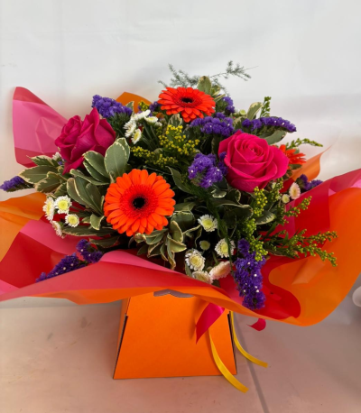 Hallie - A vibrant flower box bursting with seasonal flowers in orange, purple, Cerise & white
